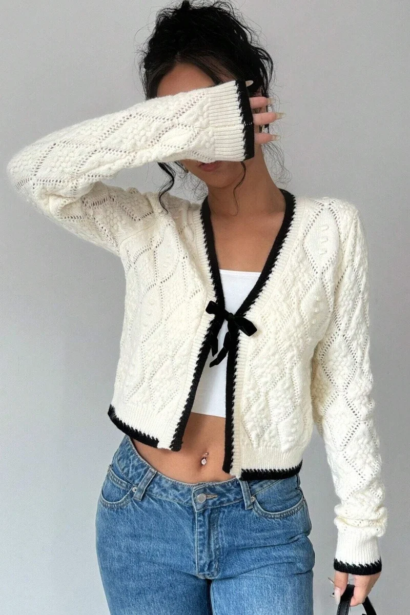 Kurze Strickjacke mit Lochmuster, Schleife und kontrastfarbenen Bordüren – Mila